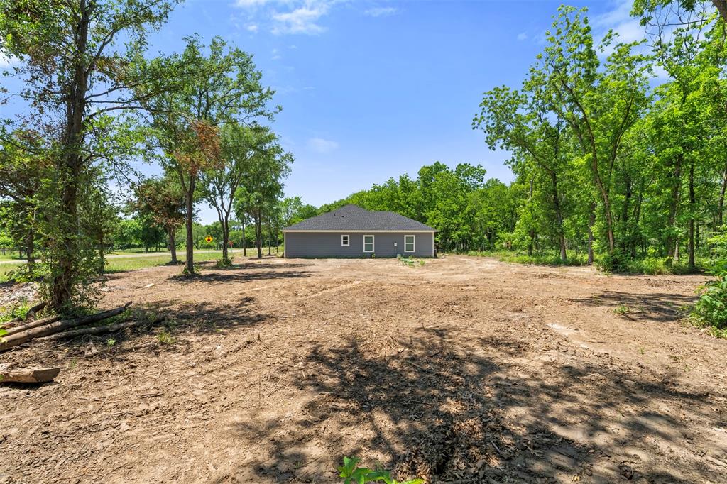 1011 Southeast County Road Corsicana, TX 75109 - Photo 32 of 40 a view of outdoor space with deck and trees