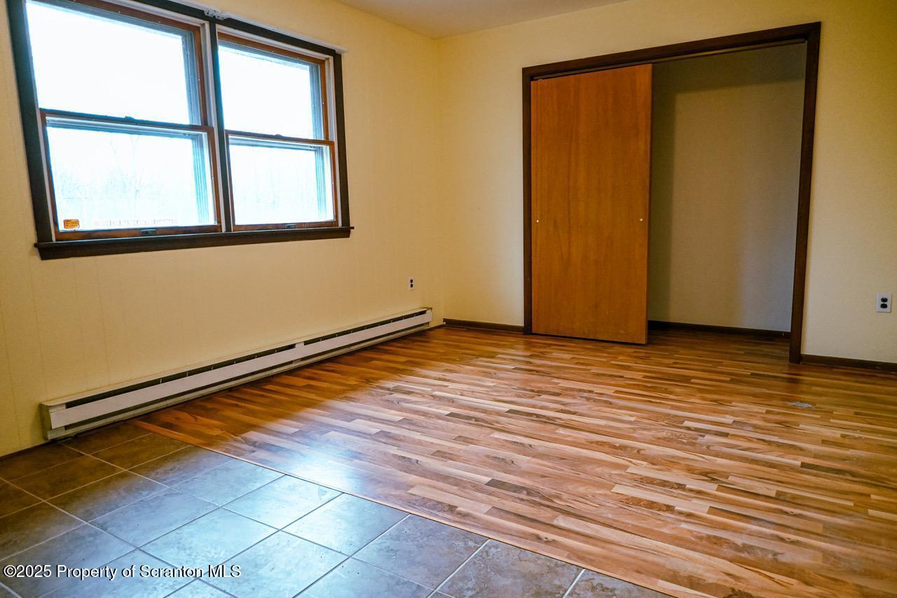 211 Wimmers Road Lake Ariel, PA 18436 - Photo 22 of 65 a view of an empty room with wooden floor and a window