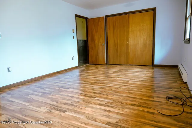 a view of a room with wooden floor and entrance