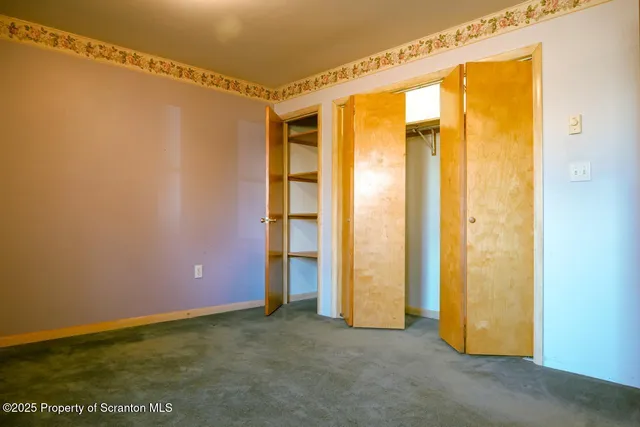a view of a room with wooden floor and a window