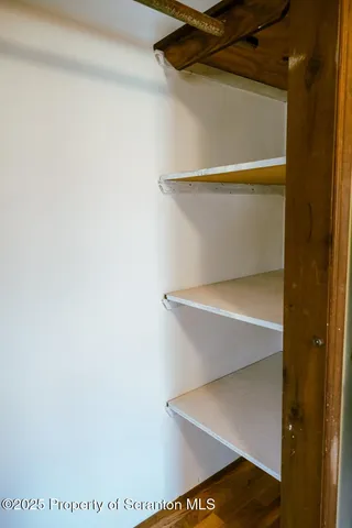 a view of a bathroom with shower and mirror
