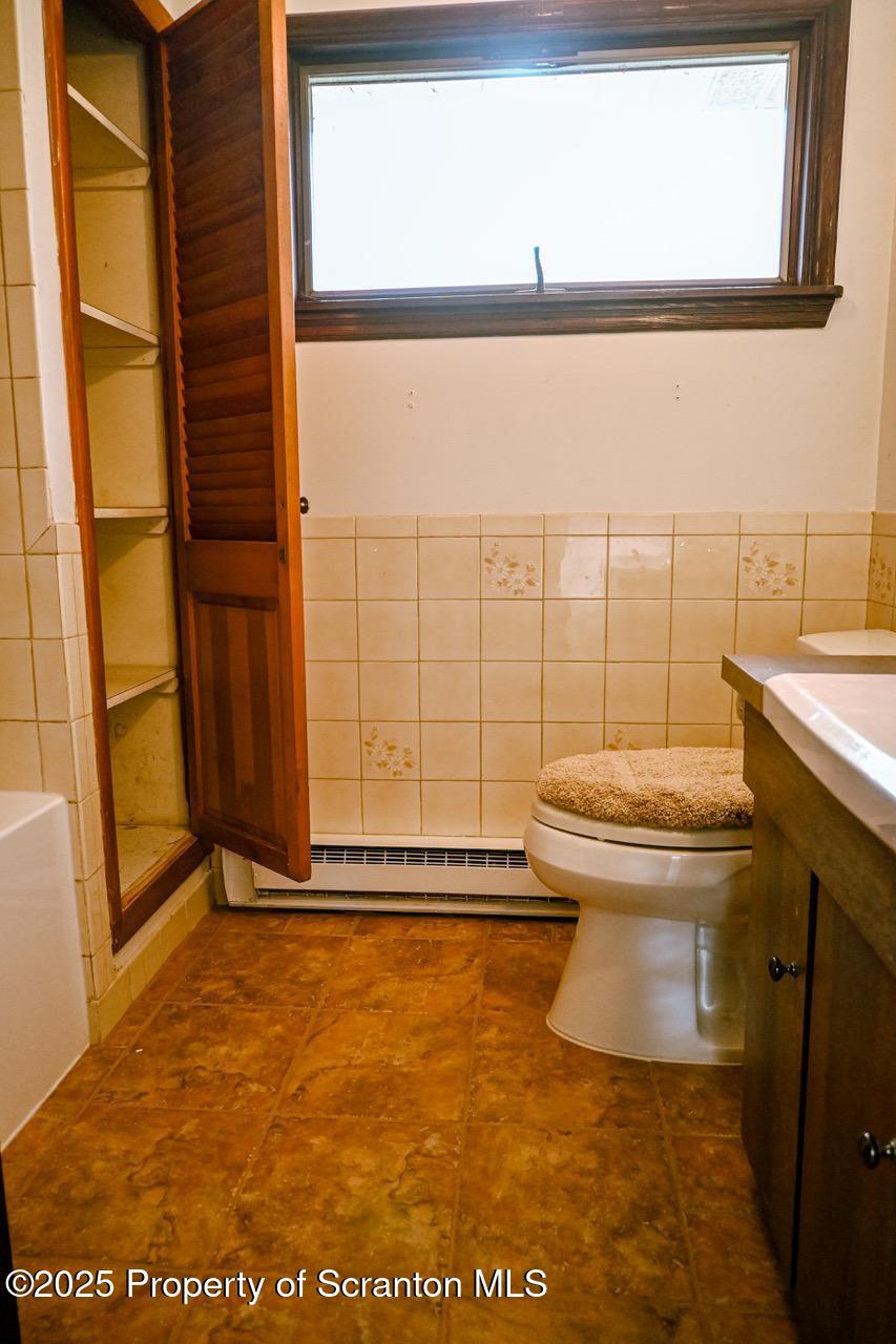 211 Wimmers Road Lake Ariel, PA 18436 - Photo 58 of 65 a bathroom with a toilet a sink and a window