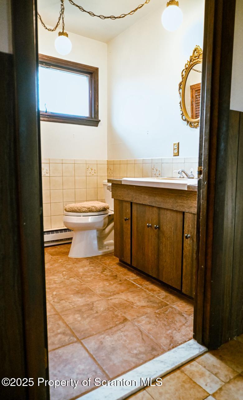 211 Wimmers Road Lake Ariel, PA 18436 - Photo 62 of 65 a bathroom with a toilet a sink and a mirror