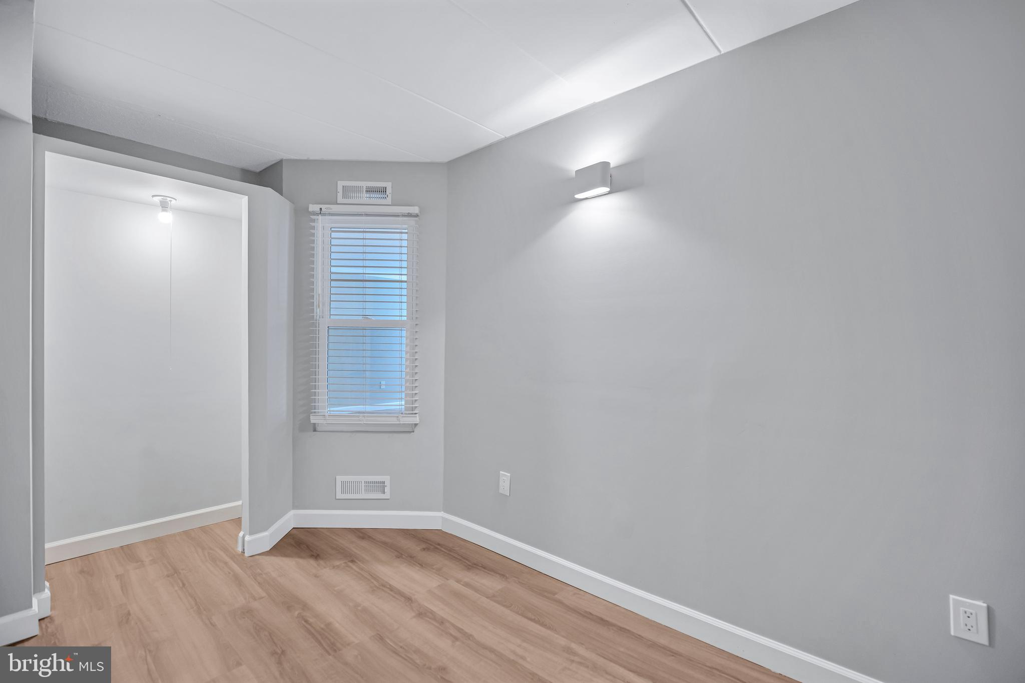 2605 Fort Farnsworth Road, Unit 314 Alexandria, VA 22303 - Photo 19 of 34 a view of an empty room with wooden floor and a window