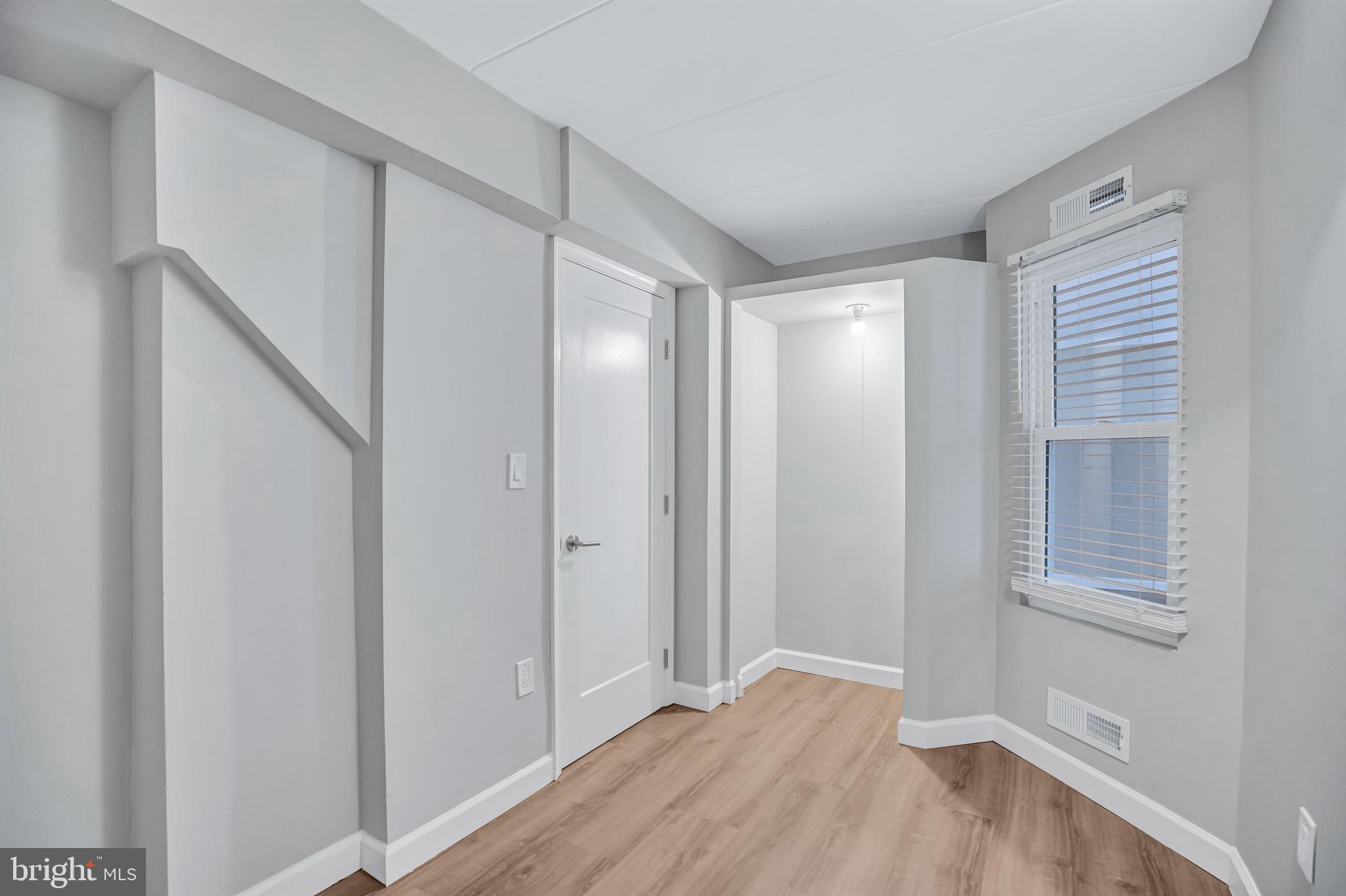 2605 Fort Farnsworth Road, Unit 314 Alexandria, VA 22303 - Photo 20 of 34 a view of an empty room with wooden floor and a window