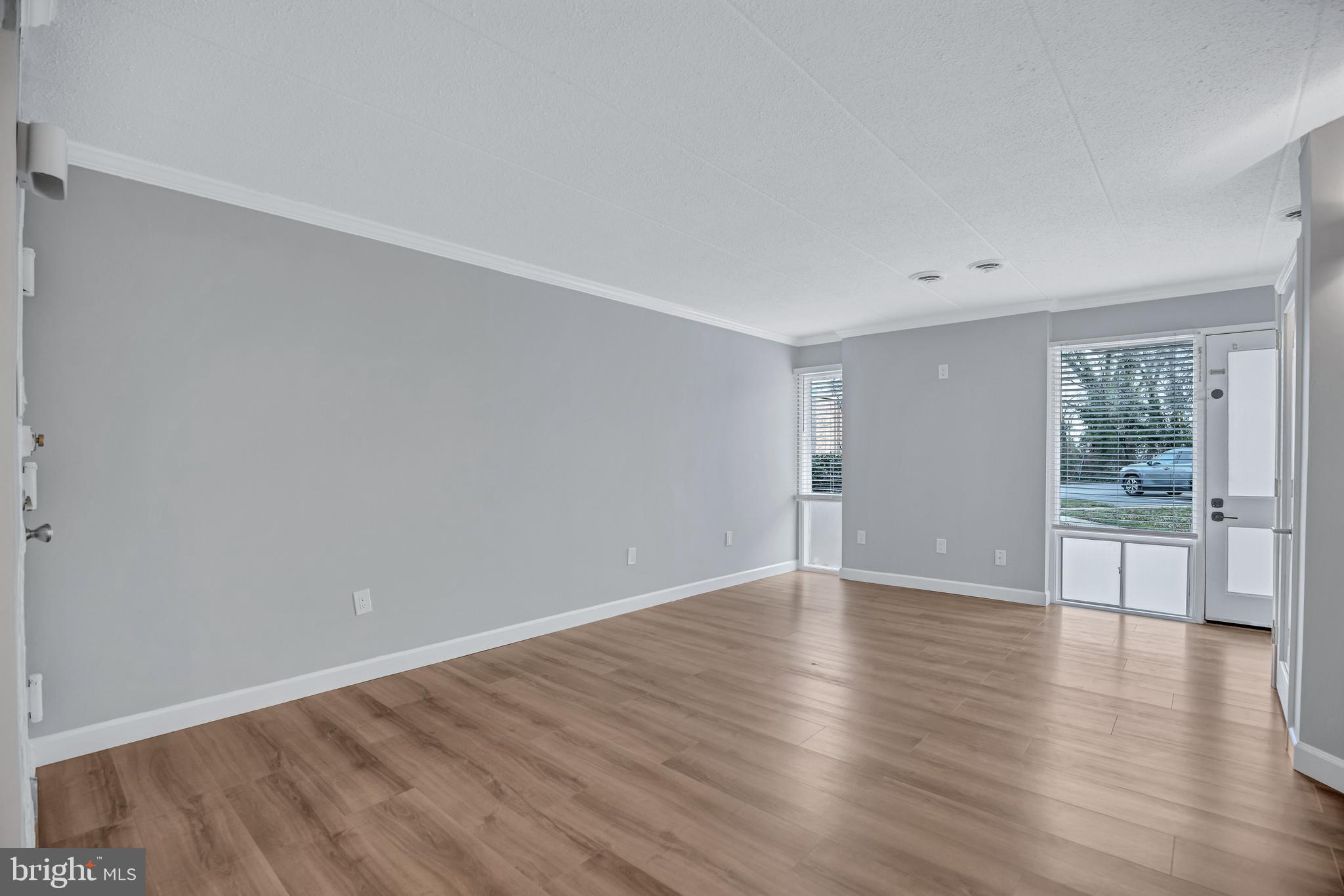2605 Fort Farnsworth Road, Unit 314 Alexandria, VA 22303 - Photo 4 of 34 a view of an empty room with wooden floor and a window