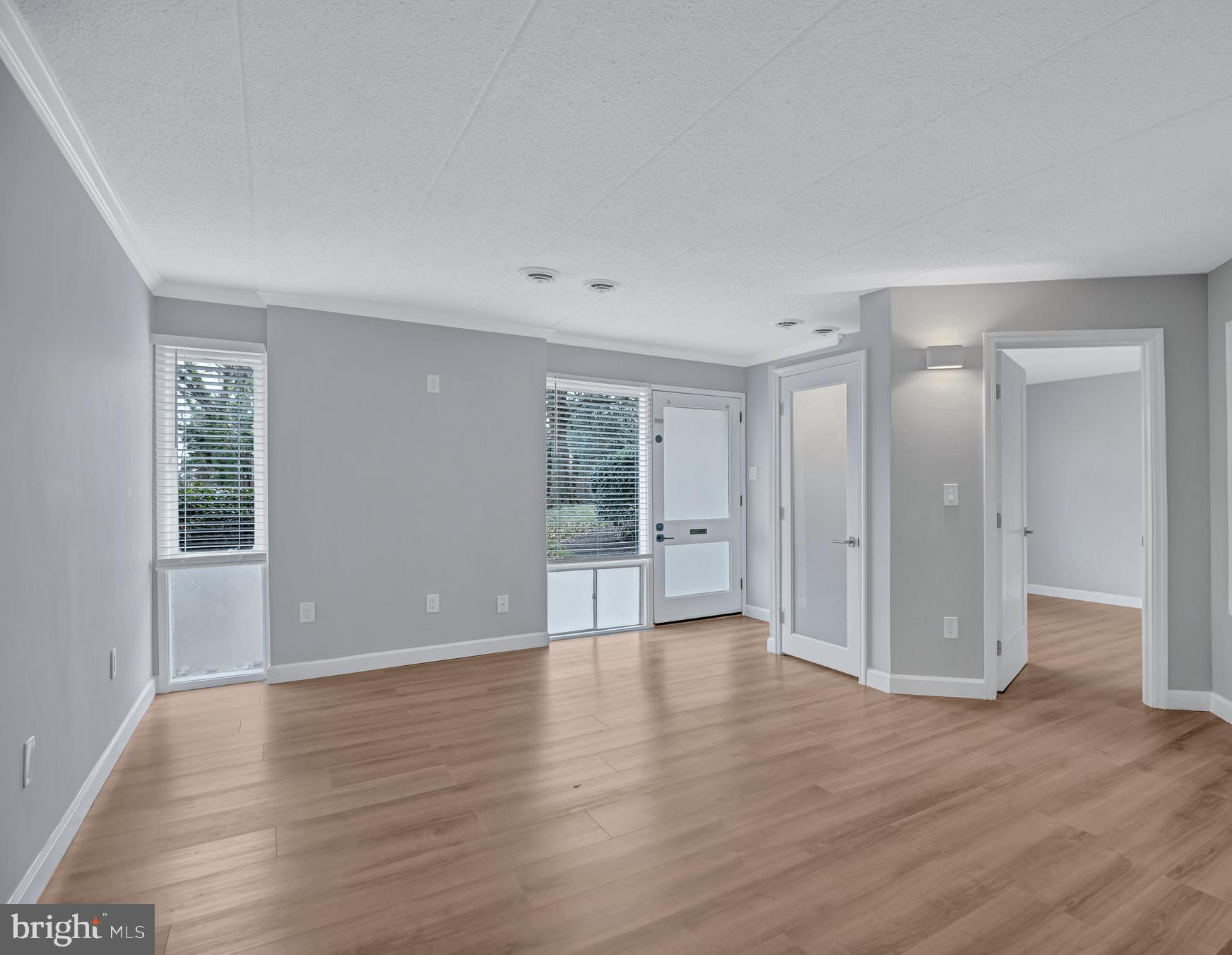 2605 Fort Farnsworth Road, Unit 314 Alexandria, VA 22303 - Photo 5 of 34 a view of an empty room with wooden floor and window