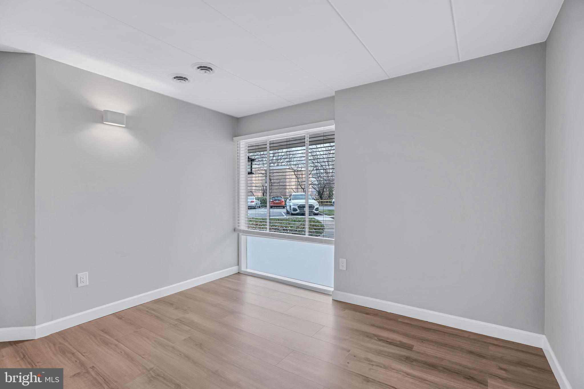 2605 Fort Farnsworth Road, Unit 314 Alexandria, VA 22303 - Photo 7 of 34 a view of an empty room with wooden floor and a window