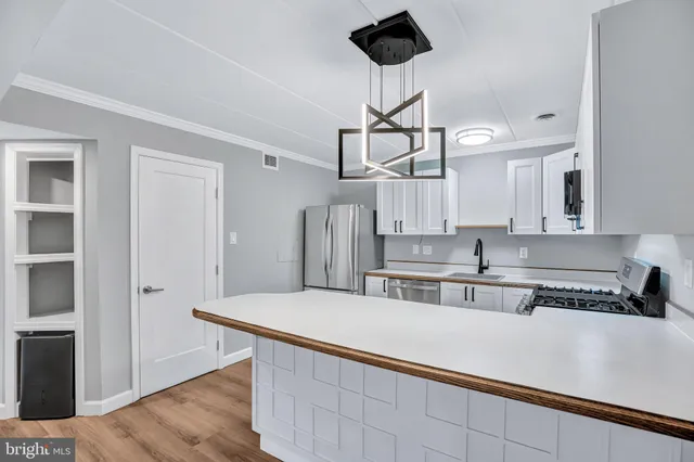 a kitchen with stainless steel appliances a sink and stove