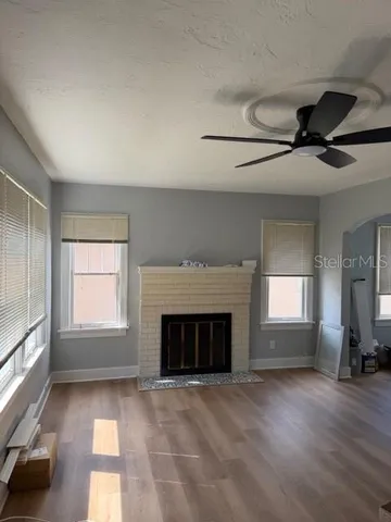 a view of empty room with a fireplace