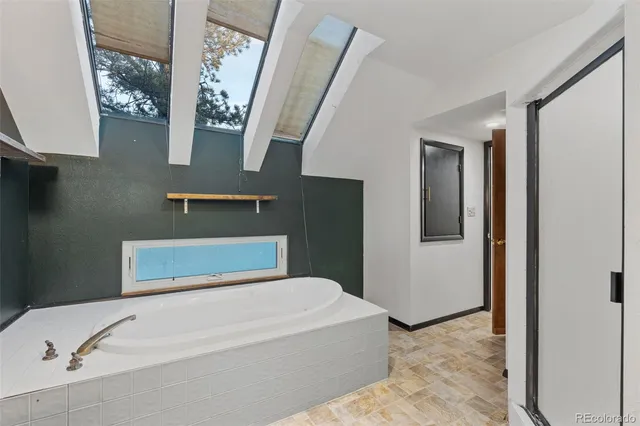 an empty room with a chandelier fan