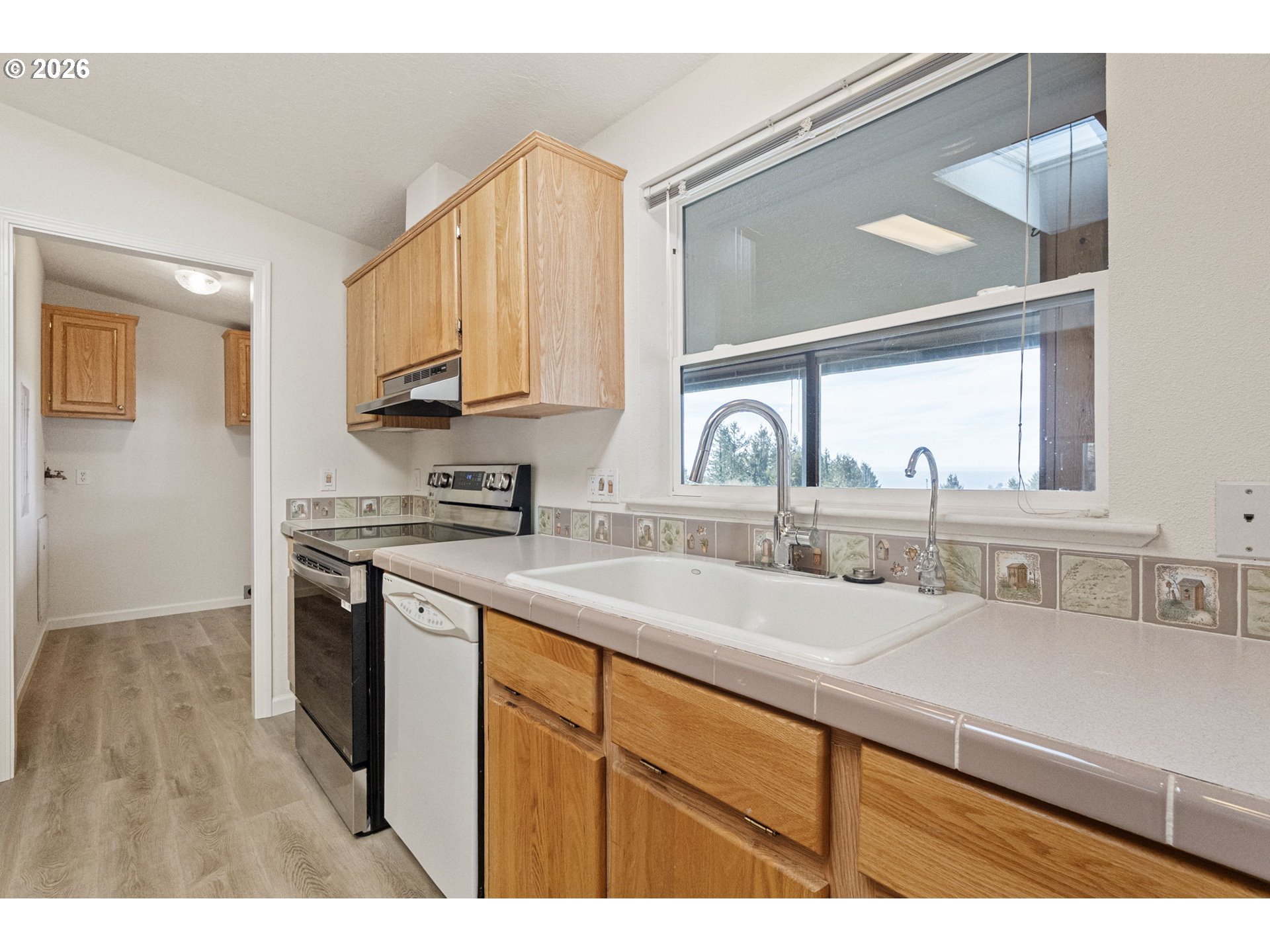 98041 Hallway Road, Unit 41 Brookings, OR 97415 - Photo 11 of 48 a kitchen with a sink cabinets and a wooden floor