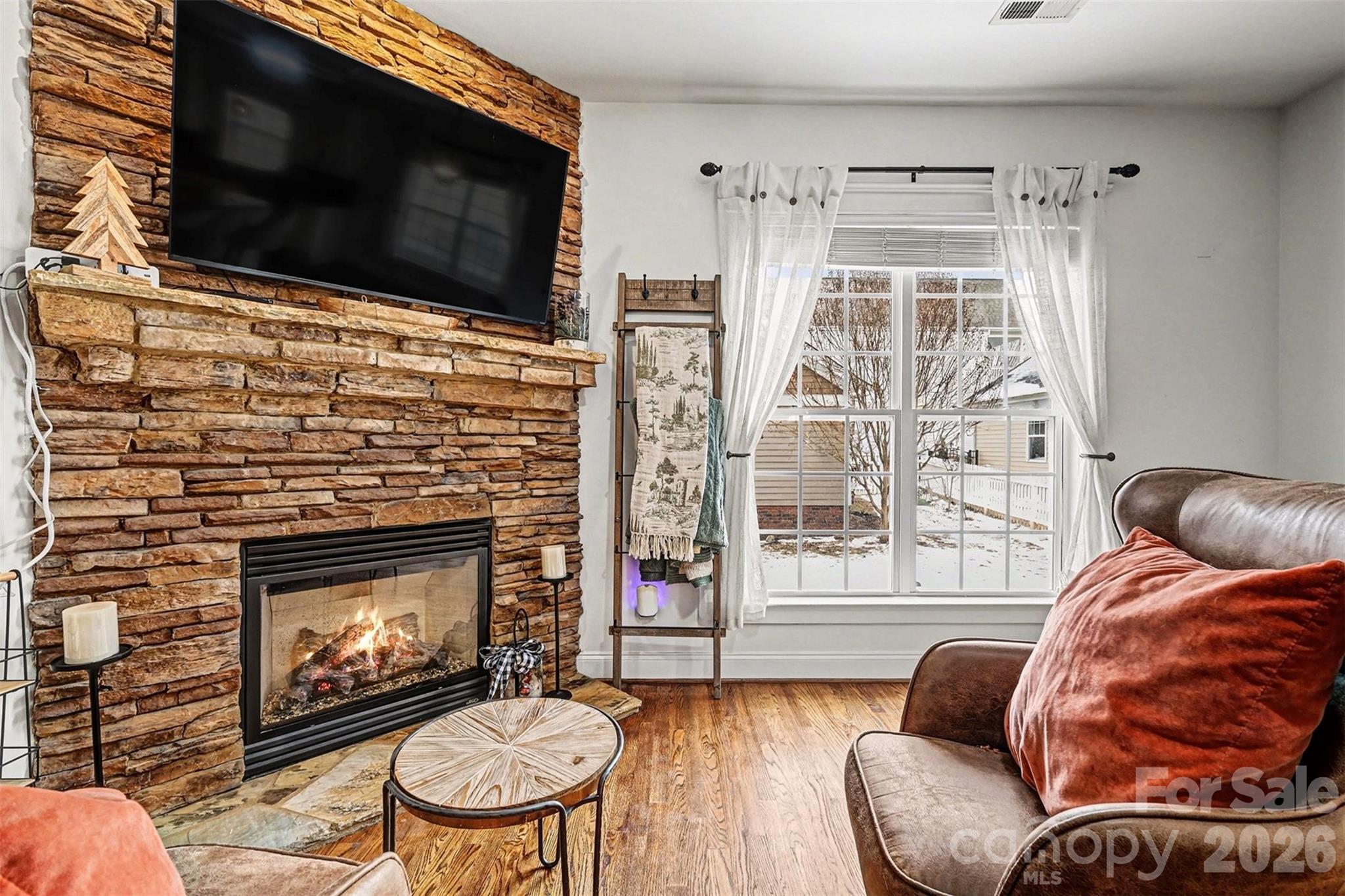 191 Lilac Mist Loop Mooresville, NC 28115 - Photo 11 of 44 a living room with furniture a flat screen tv and a fireplace