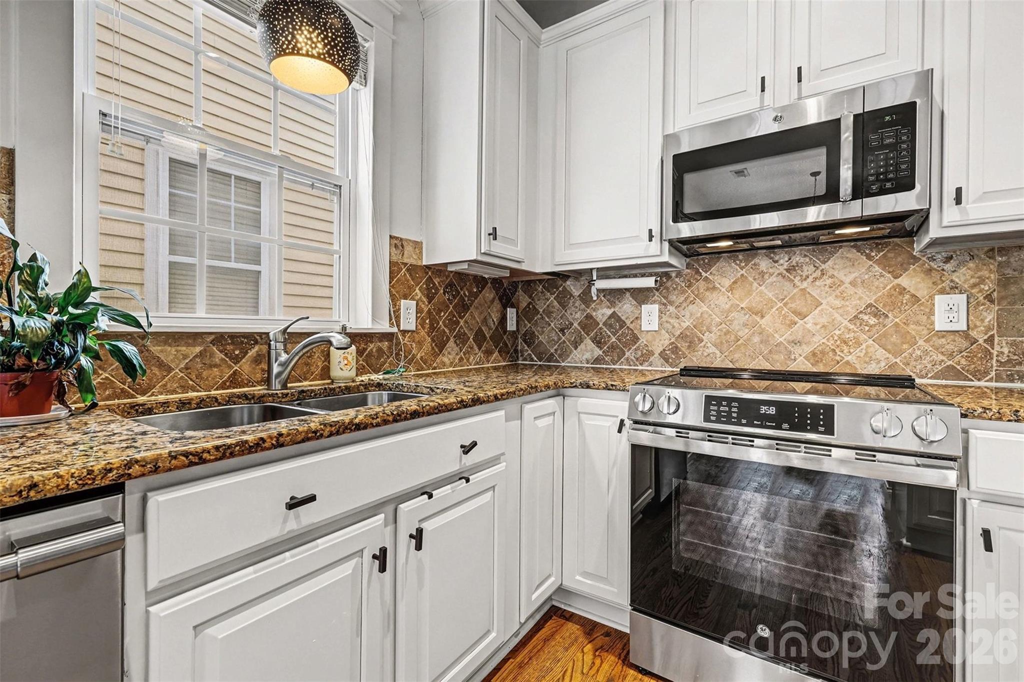 191 Lilac Mist Loop Mooresville, NC 28115 - Photo 15 of 44 a kitchen with stainless steel appliances granite countertop a stove a microwave and cabinets