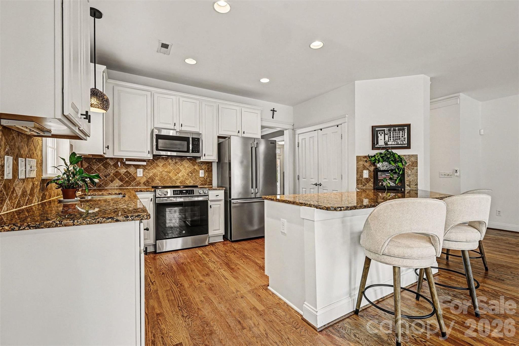 191 Lilac Mist Loop Mooresville, NC 28115 - Photo 16 of 44 a kitchen with stainless steel appliances a refrigerator stove microwave and white cabinets