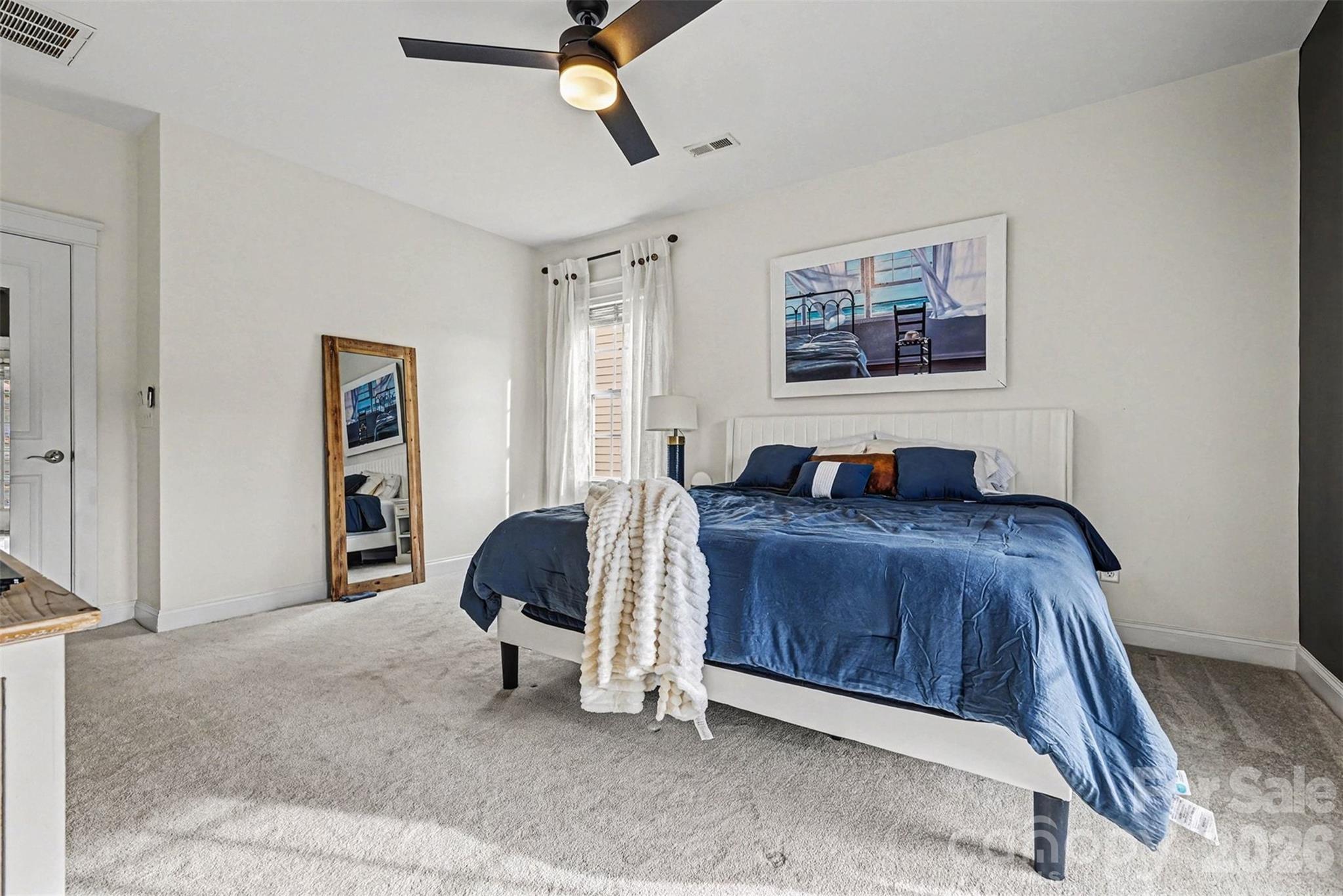 191 Lilac Mist Loop Mooresville, NC 28115 - Photo 19 of 44 a bedroom with a bed and a painting on the wall