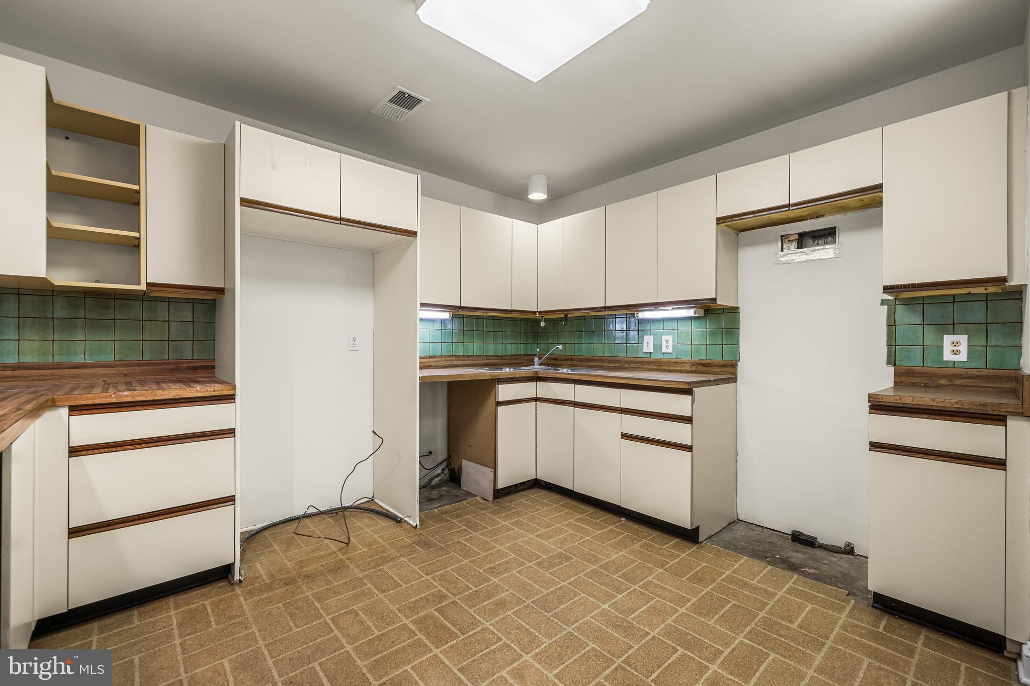 7 Devon Hill Road, Unit A4 Baltimore, MD 21210 - Photo 20 of 30 a kitchen with granite countertop white cabinets and stainless steel appliances