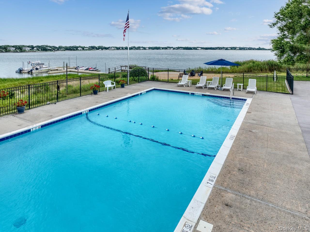61 West Tiana Road, Unit 6 Hampton Bays, NY 11946 - Photo 10 of 10 a view of a swimming pool with an ocean view
