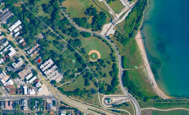 an aerial view of a residential houses with outdoor space and street view