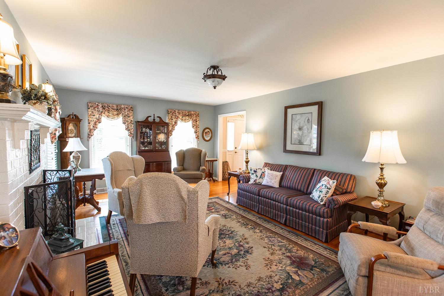 115 Hunters Creek Road Forest, VA 24551 - Photo 11 of 43 a living room with furniture a lamp and a window