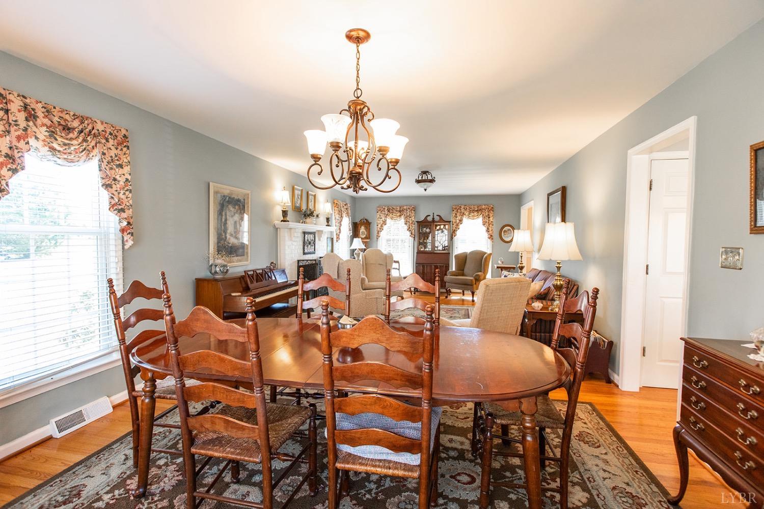 115 Hunters Creek Road Forest, VA 24551 - Photo 12 of 43 a dining room with furniture a chandelier and window