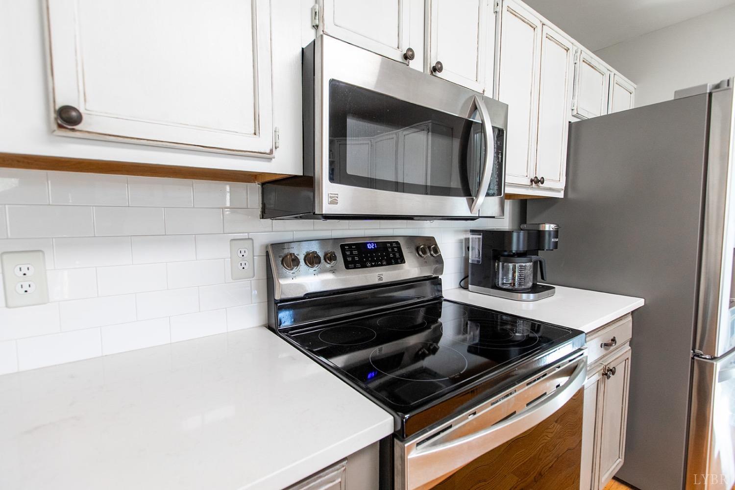115 Hunters Creek Road Forest, VA 24551 - Photo 16 of 43 a kitchen with a stove microwave and sink