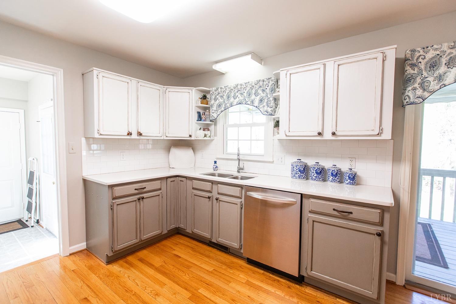 115 Hunters Creek Road Forest, VA 24551 - Photo 17 of 43 a kitchen with granite countertop white cabinets and white appliances