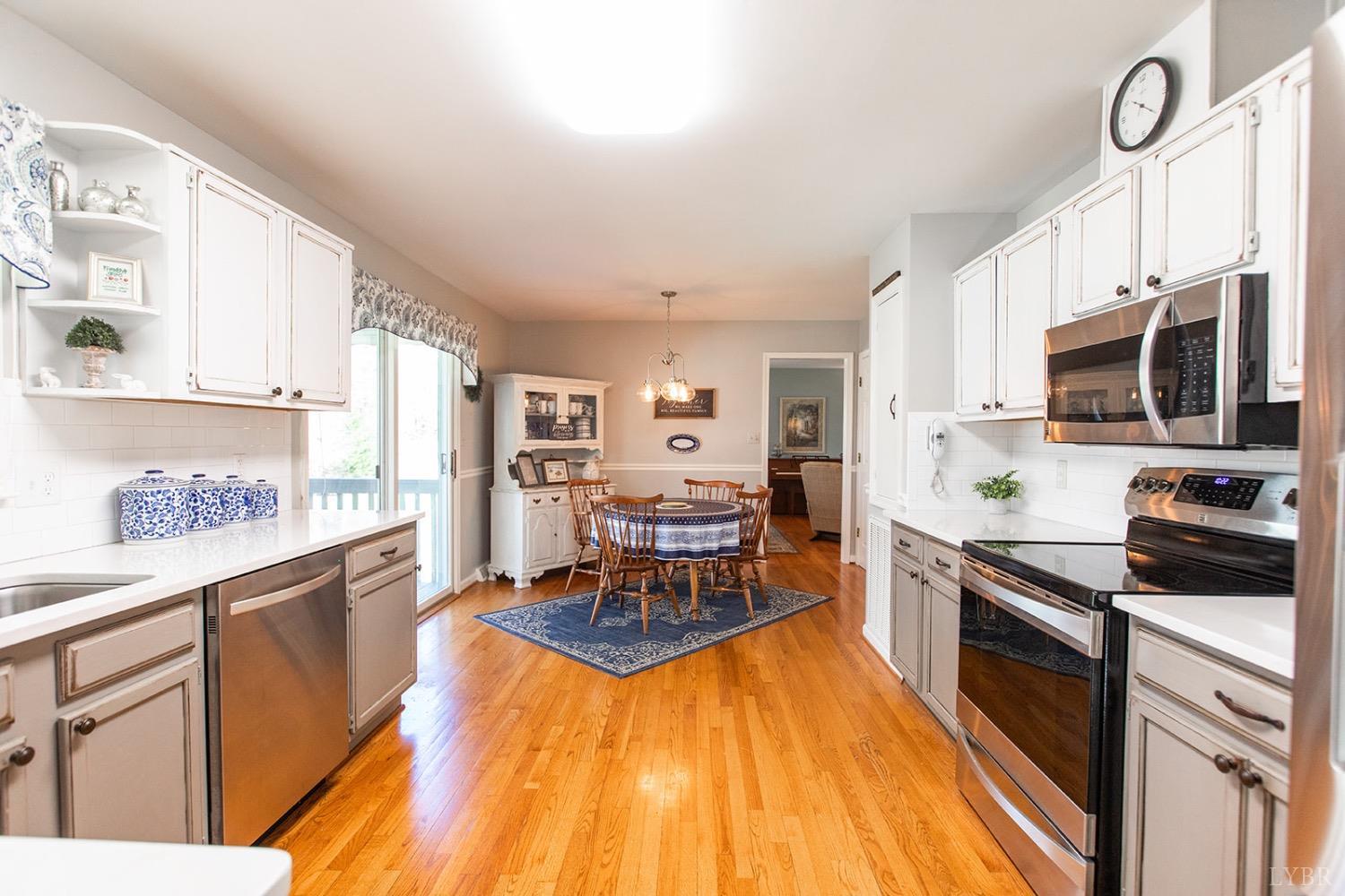 115 Hunters Creek Road Forest, VA 24551 - Photo 18 of 43 a large kitchen with stainless steel appliances granite countertop a stove and a sink