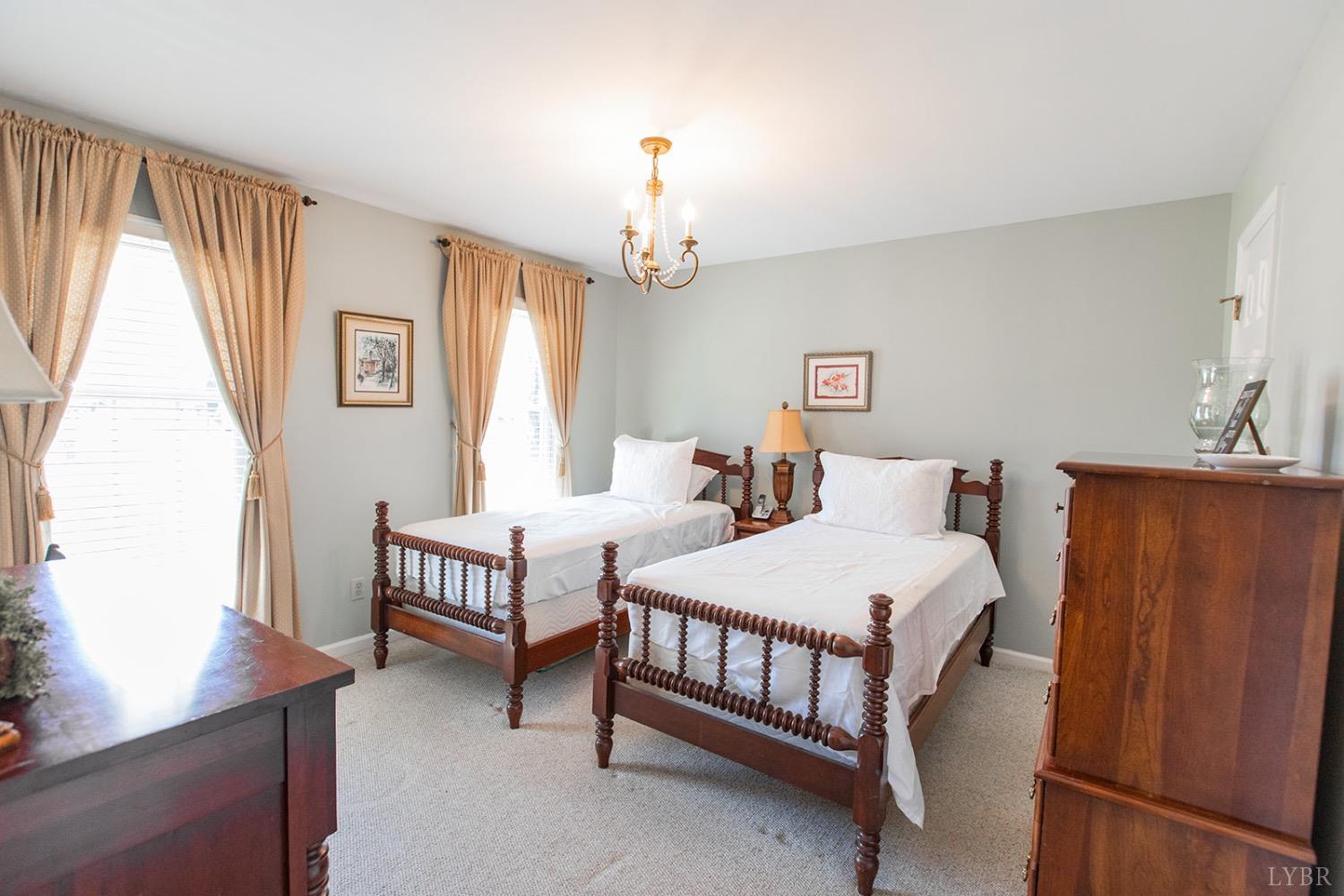 115 Hunters Creek Road Forest, VA 24551 - Photo 21 of 43 a bedroom with two beds and a table