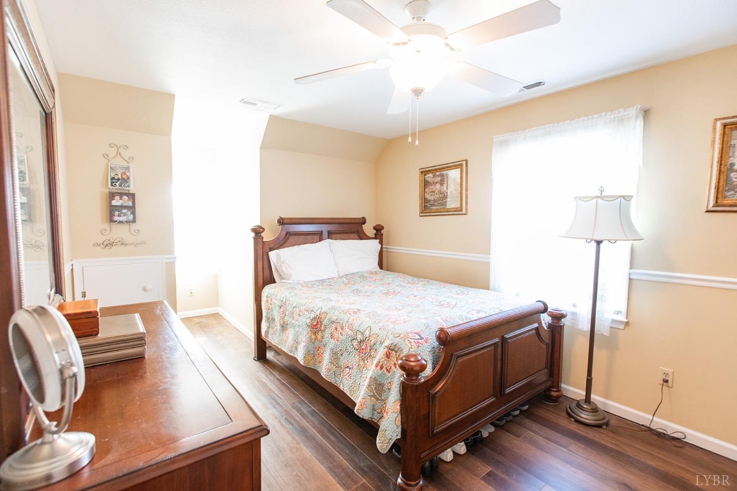 115 Hunters Creek Road Forest, VA 24551 - Photo 28 of 43 a bedroom with a bed and wooden floor