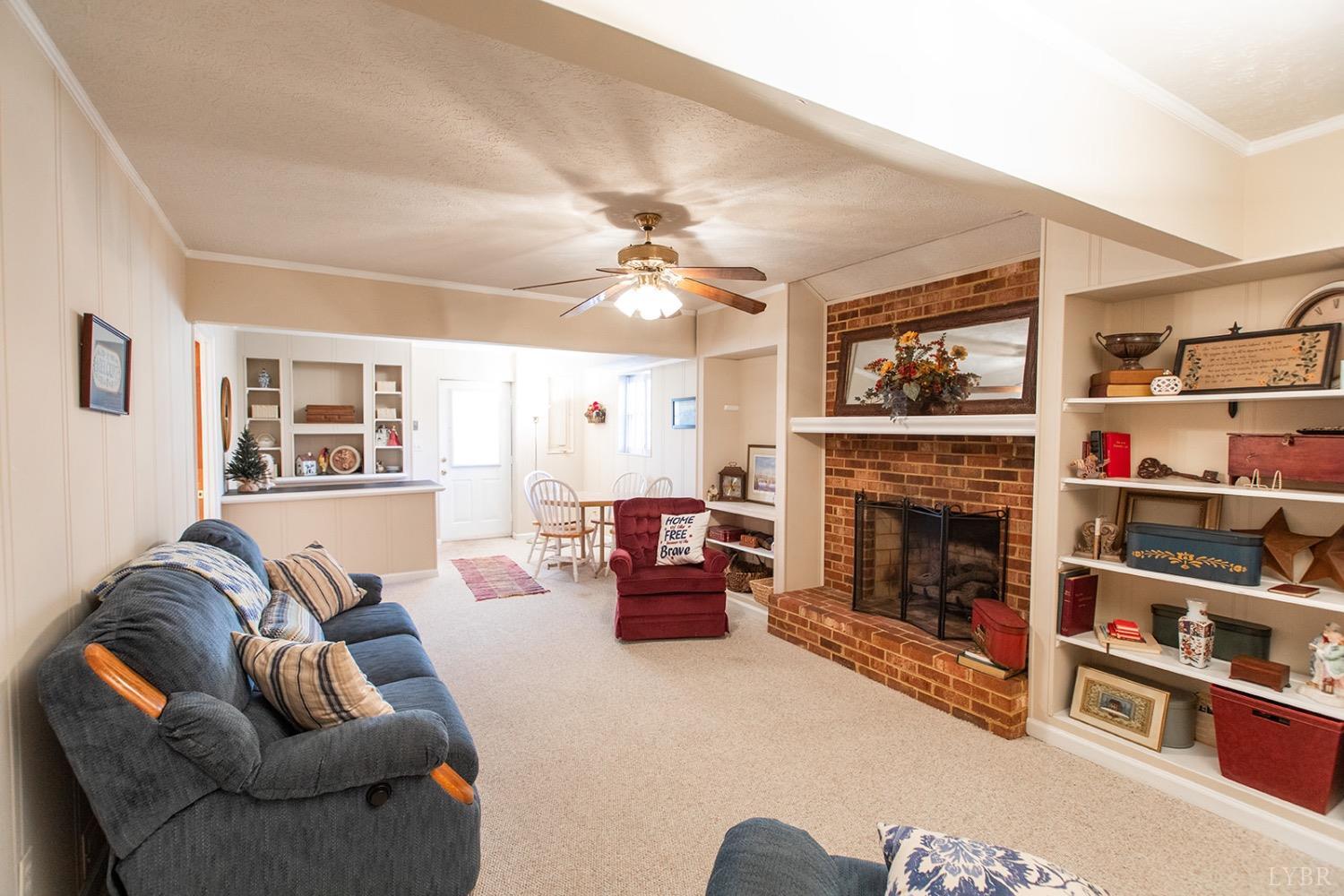 115 Hunters Creek Road Forest, VA 24551 - Photo 32 of 43 a living room with furniture a flat screen tv and a fireplace