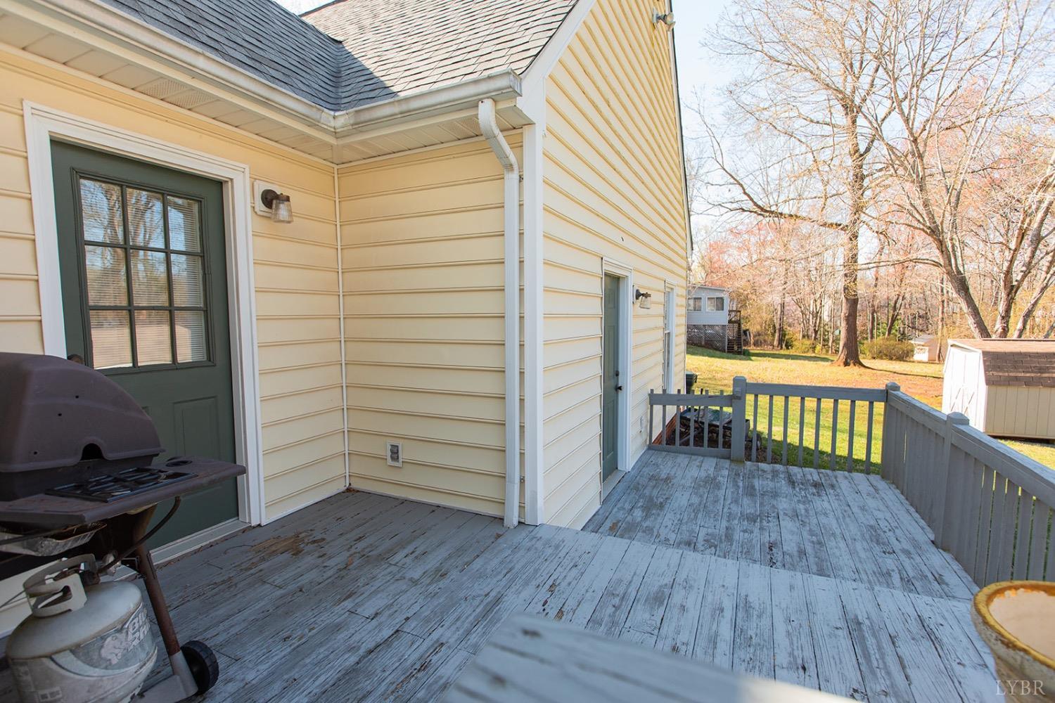 115 Hunters Creek Road Forest, VA 24551 - Photo 36 of 43 a view of a porch with wooden floor and outdoor seating