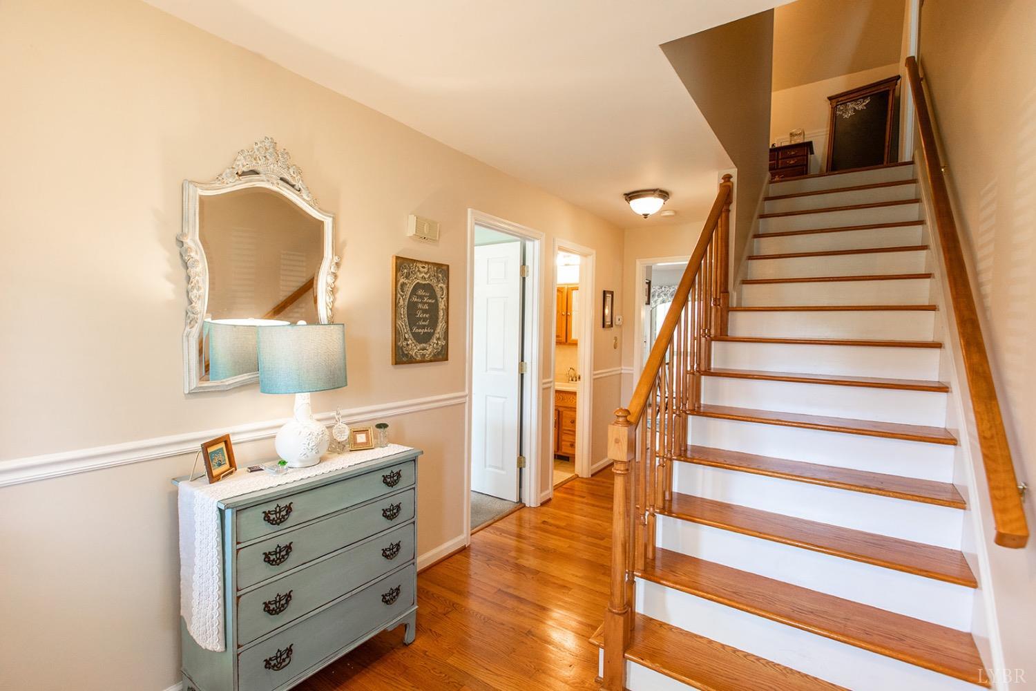 115 Hunters Creek Road Forest, VA 24551 - Photo 6 of 43 a view of hallway with stairs and wooden floor