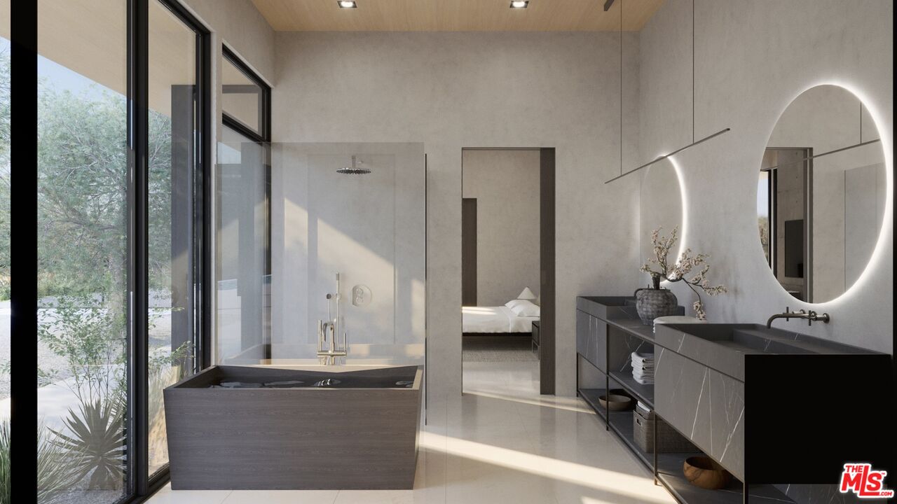 6658 Wandermere Road Malibu, CA 90265 - Photo 11 of 21 a en suite bathroom with a double vanity sink a mirror and a large mirror