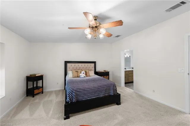 a bedroom with a bed and a ceiling fan