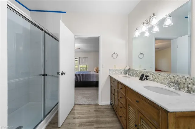 a spacious bathroom with a double vanity sink mirror and shower