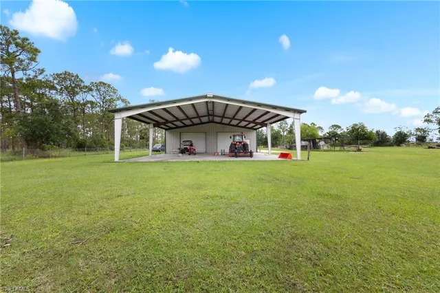 a view of a yard with large trees