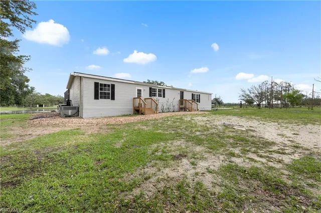a view of a big yard with large trees