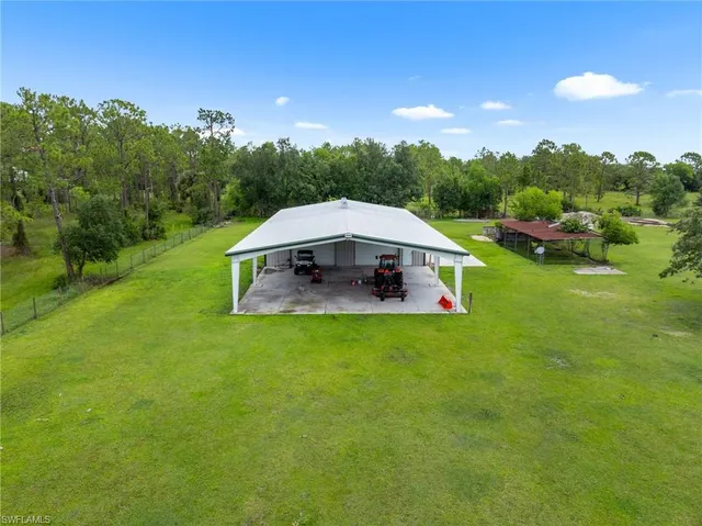an aerial view of residential house with outdoor space and swimming pool