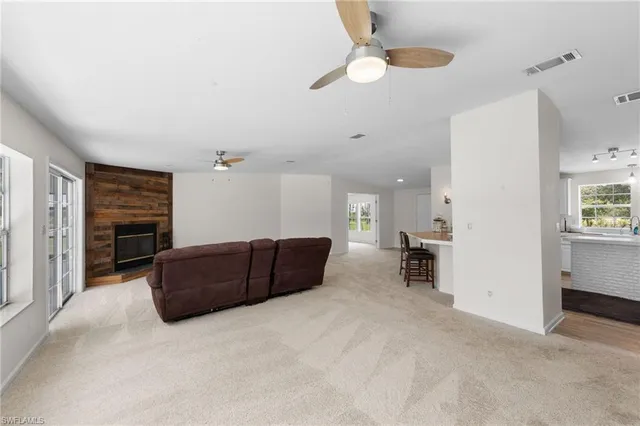 a living room with furniture and a ceiling fan