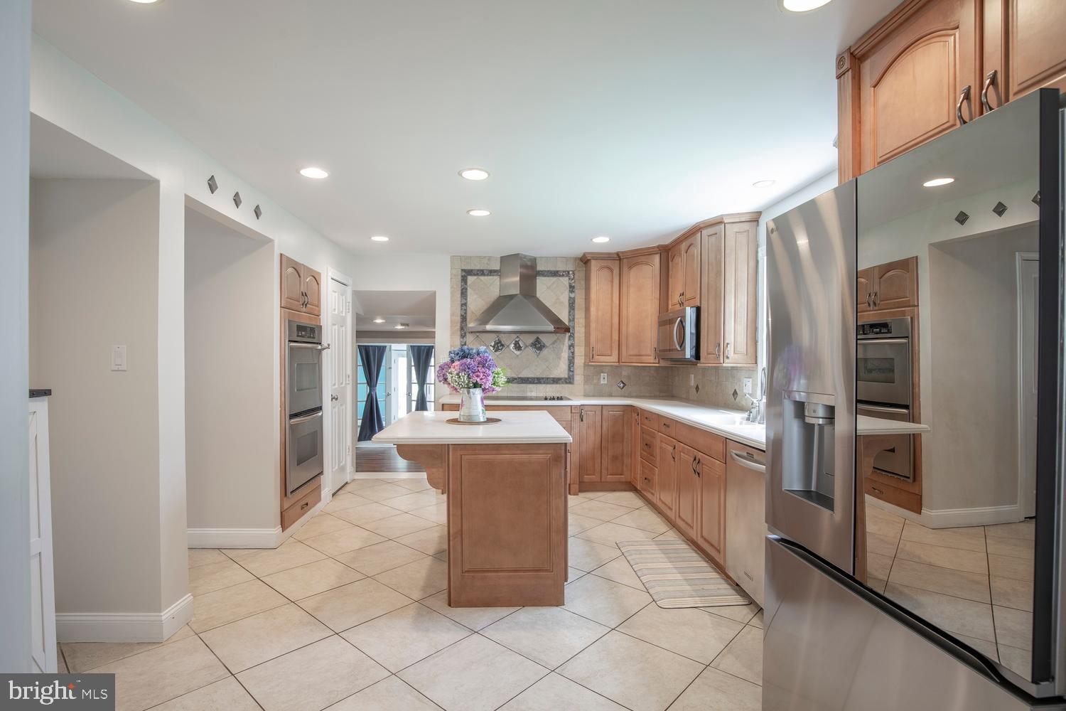 251 Upper Holland Road Richboro, PA 18954 - Photo 11 of 41 a kitchen with stainless steel appliances kitchen island granite countertop a refrigerator and a stove