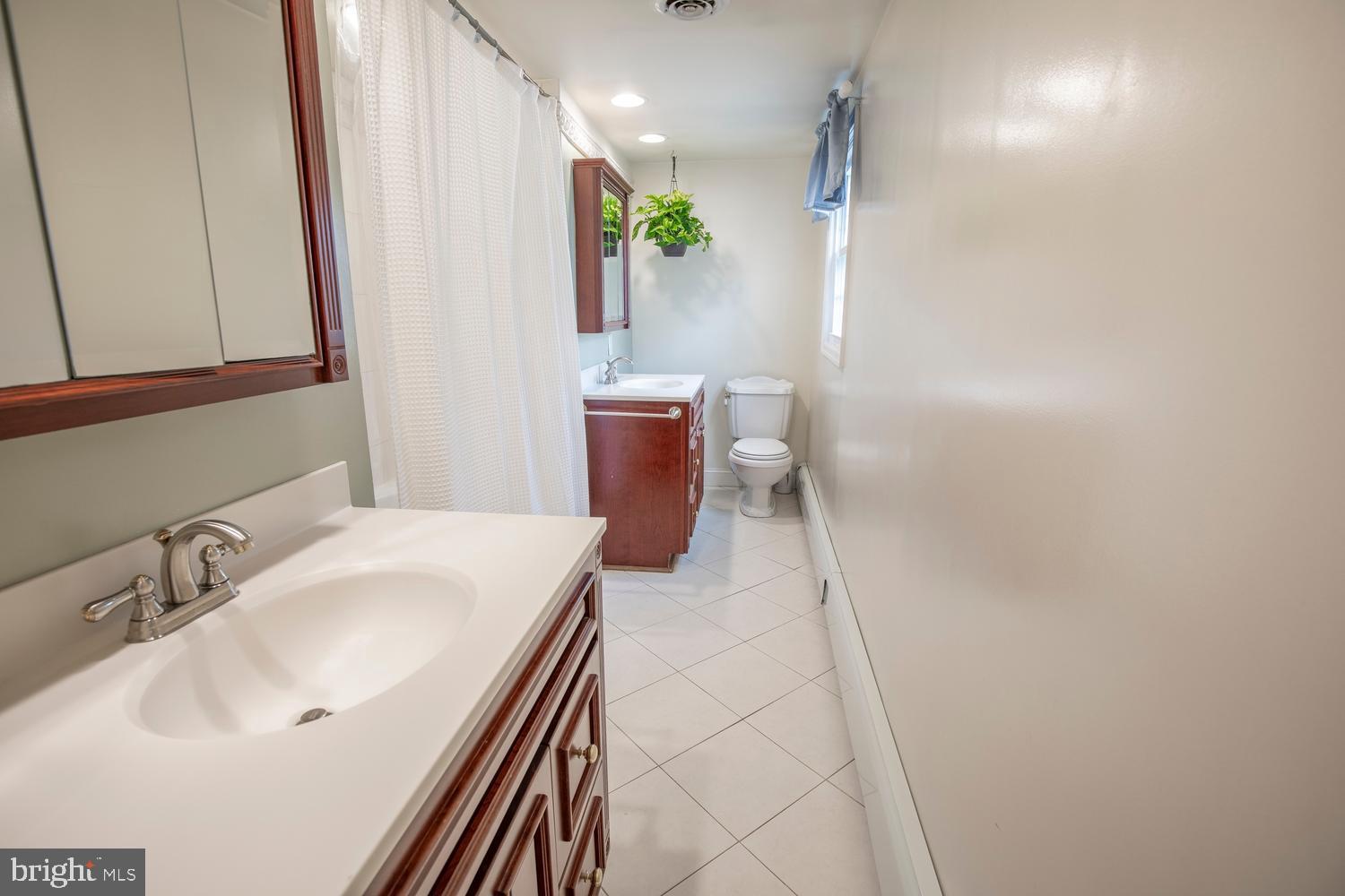 251 Upper Holland Road Richboro, PA 18954 - Photo 26 of 41 a bathroom with a sink a toilet and a mirror