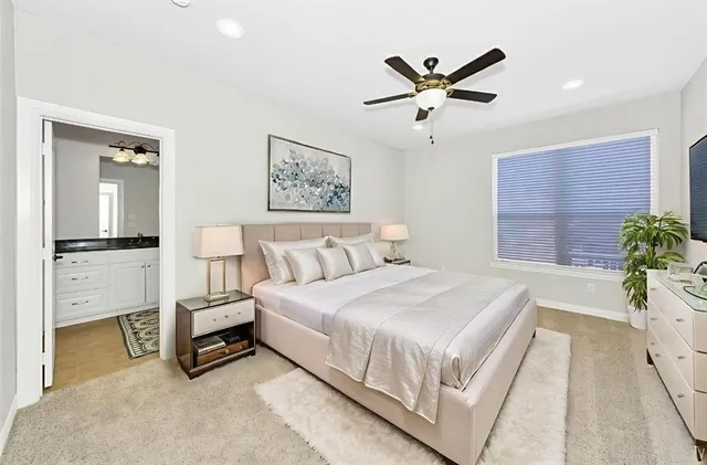a bedroom with a bed and a potted plant