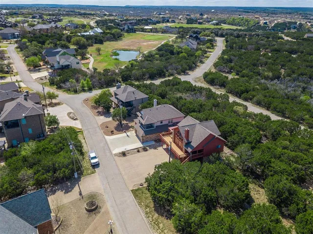 an aerial view of a house with outdoor space and lake view