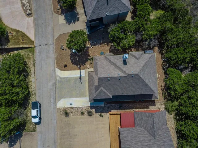 an aerial view of a house with yard