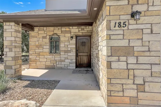 a view of a brick house with a white door
