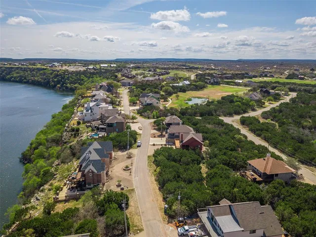 an aerial view of residential building and lake