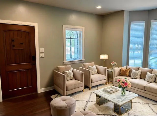 a living room with furniture and wooden floor
