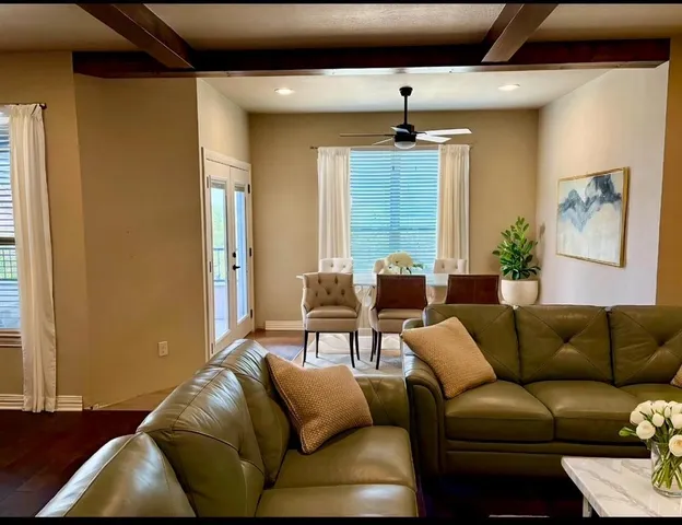 a living room with furniture and a chandelier