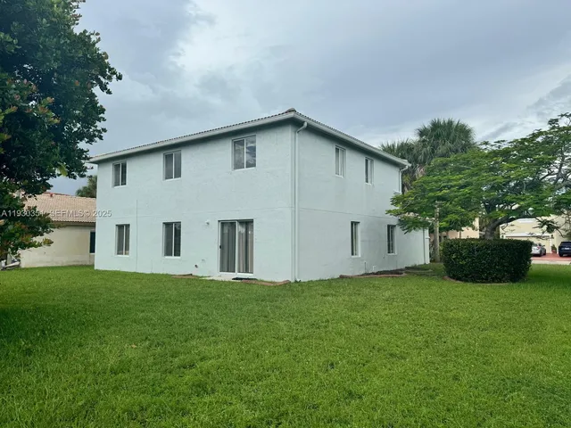 a white house that has a small garden